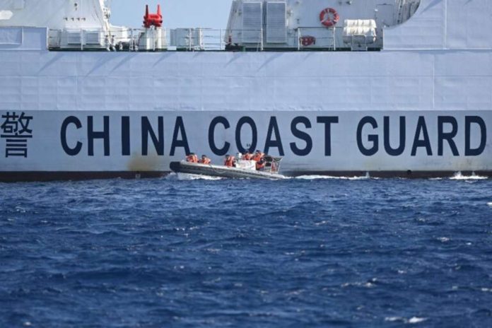 This photo, taken on February 16, 2024, shows a rigid hull inflatable boat leaving a Chinese coast guard vessel near the China-controlled Scarborough Shoal in disputed waters of the South China Sea. On February 17, the Philippines accused Chinese coast guard vessels of “dangerous” maneuvers for attempting to block a Filipino vessel dropping supplies to fishermen at a reef off the Southeast Asian nation’s coast. PHOTO BY TED ALJIBE / AFP