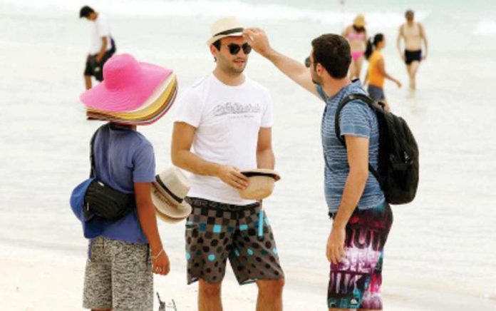 PH_tourist_arrivals_resized A foreigner tries on hat in Boracay Island in Malay, Aklan in this undated photo. BMI sees tourist arrivals in the Philippines to surpass the pre-pandemic level by 2025. PNA FILE PHOTO