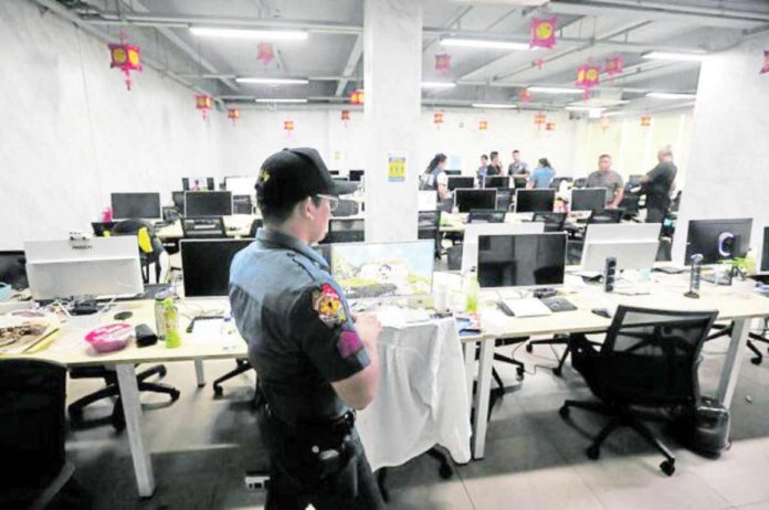 POGO_ban_resized Several lawmakers have been pushing for the ban of Philippine Offshore Gaming Operators amid the crimes being linked to them. Photo shows police officers during the raid of a POGO hub in Las Piñas City last year. INQUIRER FILE PHOTO / MARIANNE BERMUDEZ