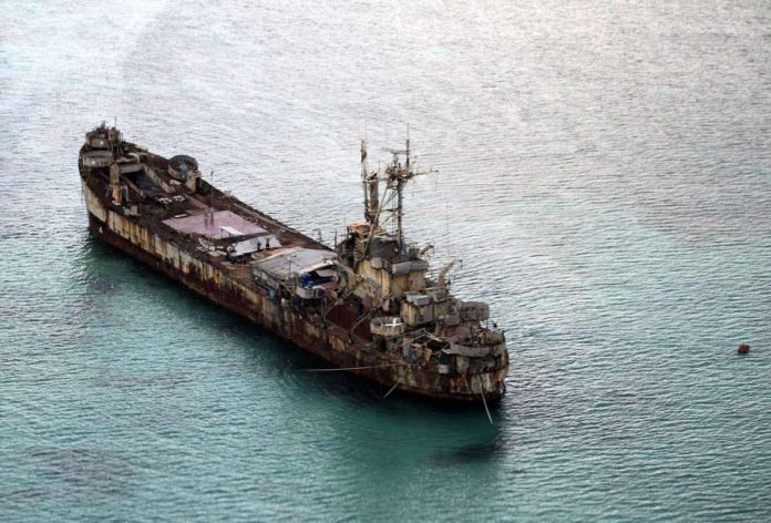 chinese_resized This aerial photograph taken from a military aircraft shows the dilapidated Sierra Madre ship of the Philippine Navy anchored near Ayungin shoal (Second Thomas Shoal) with Philippine soldiers on-board to secure the perimeter in the Spratly group of islands in the South China Sea, west of Palawan. AFP