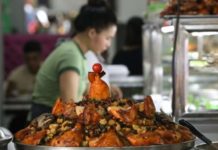 A food attendant sells a variety of halal food, including biryani for P140 per order, in Malate, Manila in this 2023 photo. Biryani is a mixed rice dish with chicken, beef, or fish, vegetables, and spices. PNA FILE PHOTO BY YANCY LIM