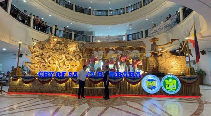 float Gov. Arthur Defensor Jr. of Iloilo Province and Mayor Dennis Superficial of Santa Barbara town inaugurate the display of the “Cry of Santa Barbara” float with a ceremonial illumination at the Iloilo Provincial Capitol lobby. IME SORNITO/PN