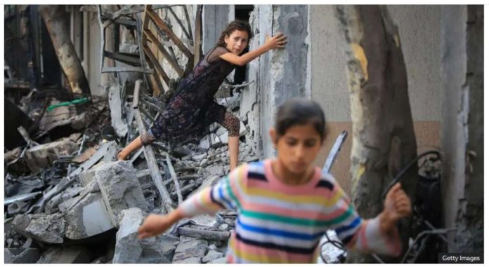 gaza_resized Children climb through debris in the Gaza Strip. The Hamas-run health ministry in Gaza says the death toll there has surpassed 37,000 since Israel responded to its attack on October 2023. GETTY IMAGES