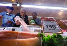 The Department of Agriculture Agribusiness and Marketing Assistance Service, led by Undersecretary Deogracias Victor Savellano (center), inspects various meat products at a supermarket in Muñoz, Quezon City on May 28, 2024. The inspection was conducted to inform the public that there is sufficient, safe and affordable supply of meat products in the market. MARIA TAN/ABS-CBN NEWS PHOTO