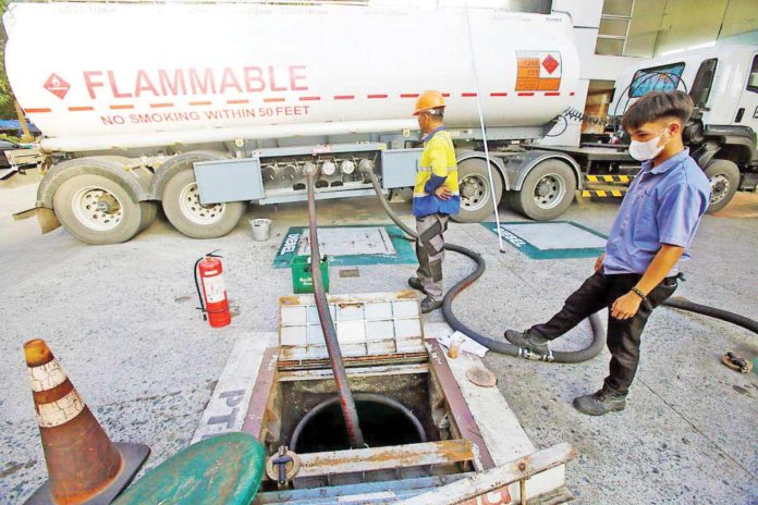 major_rollback_resized A gasoline station’s underground tank is refilled with gasoline from a fuel tanker, at the corner of Blumentritt Street and España Boulevard in Metro Manila. DANNY PATA/FILE PHOTO