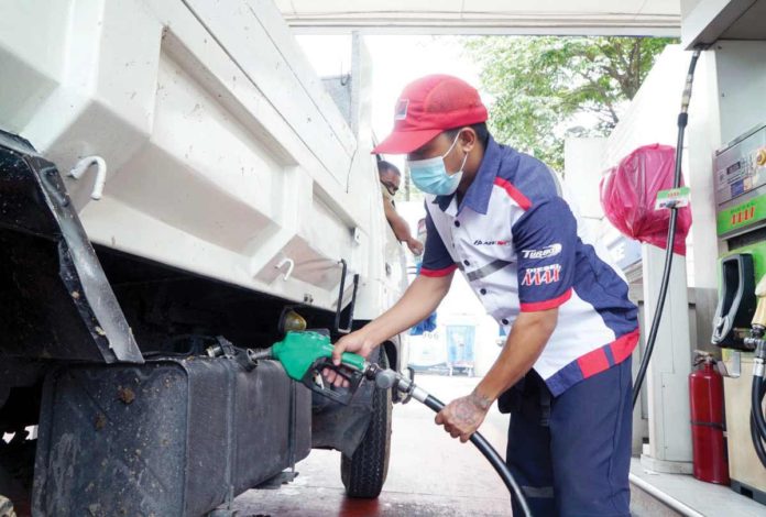 pump_price_hike_resized A Petron gasoline station attendant fills up the truck fuel tank. Petron Corp. will hike prices per liter of gasoline by P1.40, diesel by P1.75, and kerosene by P1.05 today, June 25. PNA PHOTO BY BEN BRIONES