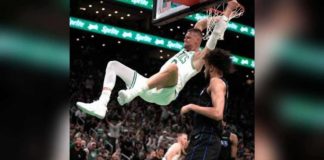 Boston Celtics’ Kristaps Porzingis hangs into the ring after completing a two-handed dunk. AP PHOTO