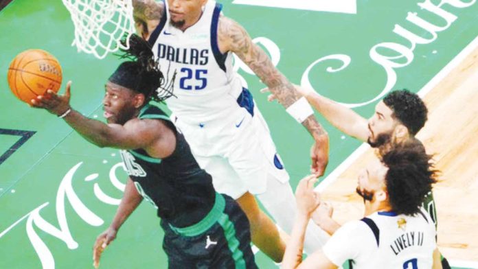 Boston Celtics guard Jrue Holiday goes for a tough reverse layup. PHOTO COURTESY OF BOSTON GLOBE