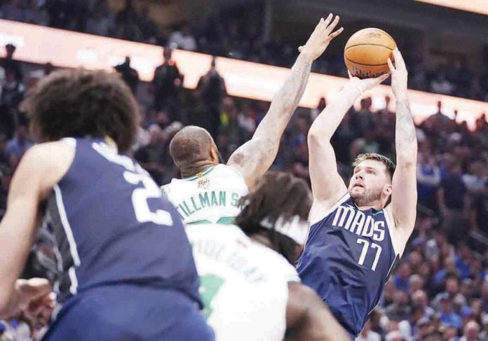 sports_Dallas_resized Dallas Mavericks’ Luka Doncic shoots over the defense of Boston Celtics’ Xavier Tillman Sr. AP