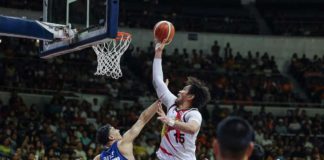 San Miguel Beermen’s June Mar Fajardo towers over the defense of Meralco Bolts’ Brandon Bates for an inside hit. PBA PHOTO