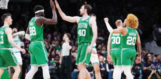 Neemias Queta (88) and Luke Kornet (40) exchange high fives during Boston Celtics’ recent game in the 2023-2024 NBA Season. Photo courtesy of USA Today Sports. 
