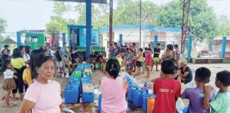 Residents of Barangay Camandag in La Castellana, Negros Occidental gets free supply of purified water on Thursday, June 6. BARANGAY CAMANDAG FACEBOK PAGE PHOTO