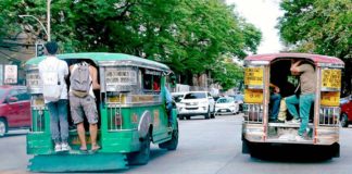One of the concerns senators are raising is the phase-out of the iconic jeepney design in favor of the so called modern jeepneys which are merely mini-buses imported from other countries. Photo shows passengers hang from the steel bars of overloaded passenger jeepneys in Timog Avenue, South Triangle, Quezon City. Riding outside or at the rear end of vehicles is against the Land Transportation and Traffic Code as it endangers the rider and other motorists.