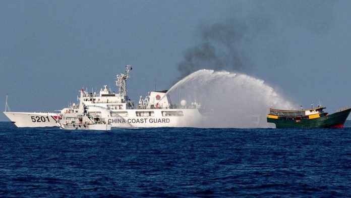 DFA_resized A Chinese Coast Guard vessel fires its water cannon at the Philippine resupply vessel Unaizah on May 4 on its way to a resupply mission at Ayungin (Second Thomas) Shoal in the West Philippine Sea. REUTERS