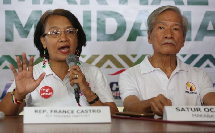 Davao_court_resized_resized Former Bayan Muna party-list representative Satur Ocampo (right) and incumbent ACT Teachers party-list’s Rep. France Castro question the decision of a court finding them guilty of child abuse. INQUIRER/NIÑO JESUS ORBETA