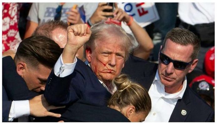 Donald.JPG_resized Despite his wounded ear, former US President Donald Trump – while being quickly covered by his Secret Service – still managed to pump his fist in the air and shout, “Fight! Fight! Fight!” Streaks of blood can be seen on his face. BBC
