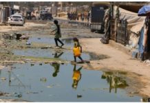 WHO warns of Gaza polio outbreak A child carrying a plastic container to get clean water passes by a street flooded with leaked sewage in the Gaza Strip. GETTY IMAGES