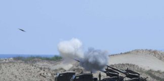 Philippine Army personnel fire their Autonomous Truck Mounted howitzer system (ATMOS), a 155 mm caliber self-propelled gun system, during the maritime strike exercise as part of the joint US-Philippines annual military Balikatan drills on a strip of sand dunes in Laoag on Luzon island’s northwest coast on May 8, 2024. FILE PHOTO/AGENCE FRANCE-PRESSE