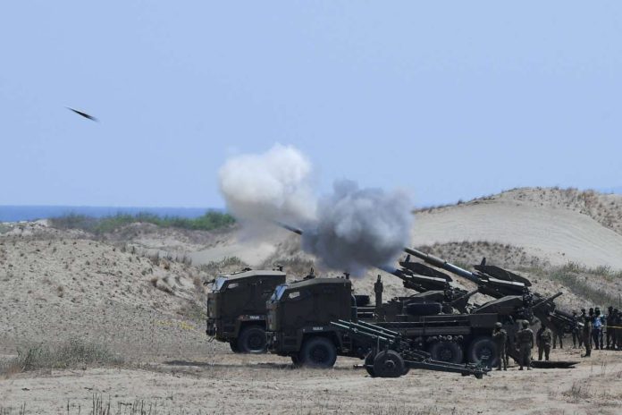 NSC_resized Philippine Army personnel fire their Autonomous Truck Mounted howitzer system (ATMOS), a 155 mm caliber self-propelled gun system, during the maritime strike exercise as part of the joint US-Philippines annual military Balikatan drills on a strip of sand dunes in Laoag on Luzon island’s northwest coast on May 8, 2024. FILE PHOTO/AGENCE FRANCE-PRESSE