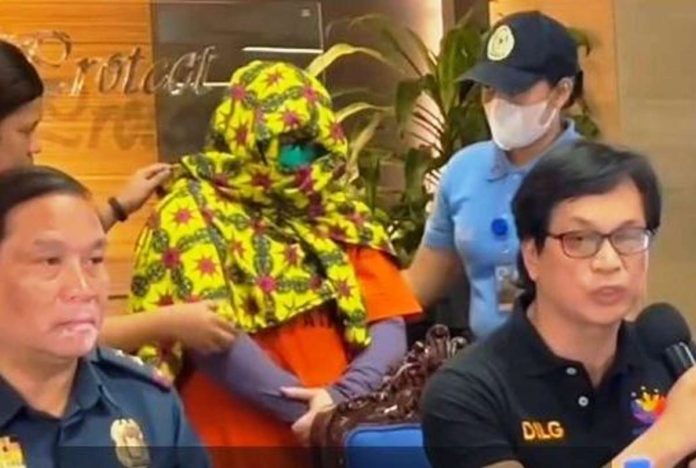 Quiboloy.JPG_resized Interior Secretary Benjamin Abalos Jr. (right) presents during a press conference a masked Paulene Canada (center), a co-accused of Kingdom of Jesus Christ founder Pastor Apollo Quiboloy. She was arrested in Davao City.