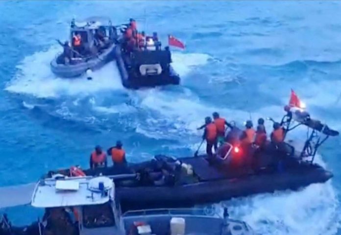 WPS_resized This frame grab from handout video footage taken on June 17, 2024 and released by the Armed Forces of the Philippines shows Chinese Coast Guard personnel aboard rigid hull inflatable boats (in black) during a confrontation with Philippine Navy personnel on their respective vessels (in gray) near the Second Thomas Shoal in disputed waters of the South China Sea. AFP