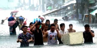Residents of Barangay Sto. Domingo, Quezon City head for a designated evacuation center as heavy rains triggered waist-deep floods on July 24, 2024. Metro Manila has been placed under a state of calamity due to massive flooding caused by continuous heavy rains brought by the Typhoon Carina-enhanced southwest monsoon. PNA