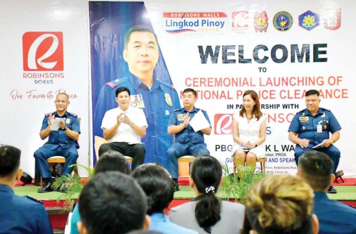police_clearance_office_resized Police Regional Office 6 director Brigadier General Jack Wanky (3rd from left) and Mayor Ronnie Dadivas (2nd from left) of Roxas City lead the launching of the National Police Clearance System at Robinsons Place Roxas on Wednesday, July 10. MAYOR RONNIE DADIVAS PHOTO