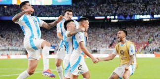 Argentina teammates run to Lautaro Martinez after he drained the game-winner against Colombia. AP PHOTO