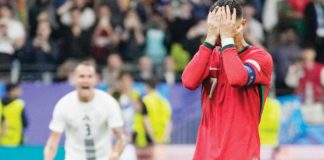 Portugal’s Cristiano Ronaldo covers his face in disappointment after missing a penalty kick during the extra-time of the knockout game against Slovenia. AP PHOTO