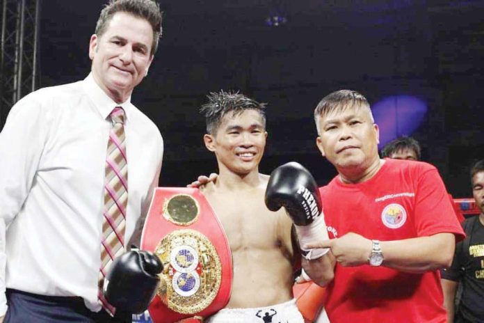 sports_pedro_resized Filipino boxer Pedro Taduran (center) reclaims the IBF minimumweight championship. PHOTO COURTESY OF PHENOM BOXING