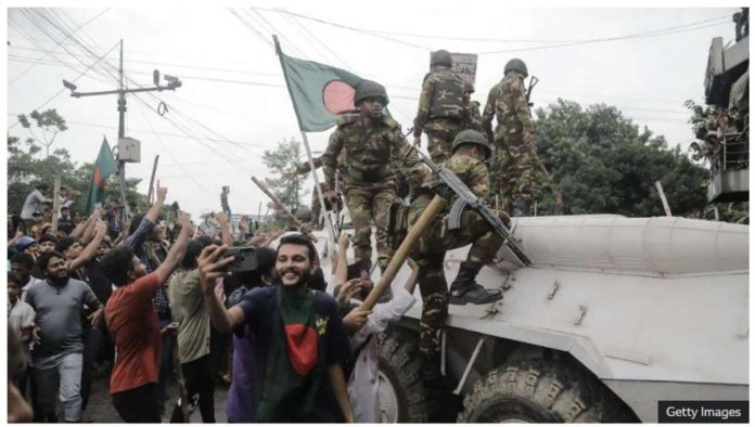 Bangladesh_resized Protesters celebrate with soldiers in Dhaka, the capital of Bangladesh. GETTY IMAGES