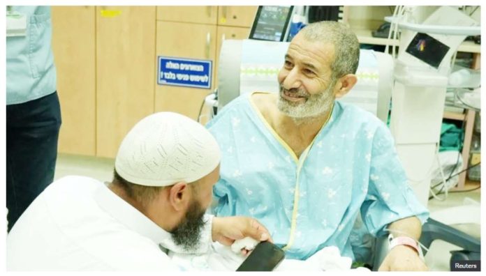 This Israeli government handout photo shows rescued Bedouin hostage Kaid Farhan Elkadi speaking to relatives at Soroka Medical Center in Beersheba, Israel after his rescue on August 27. REUTERS