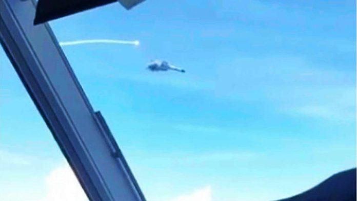 PH_resized This photo shared by a Philippine government source shows Chinese fighter jets making a “dangerous” move against a Philippine Air Force plane, firing flares into its path as it was flying over Panatag (Scarborough) Shoal on Aug. 8. PHILIPPINE DAILY INQUIRER