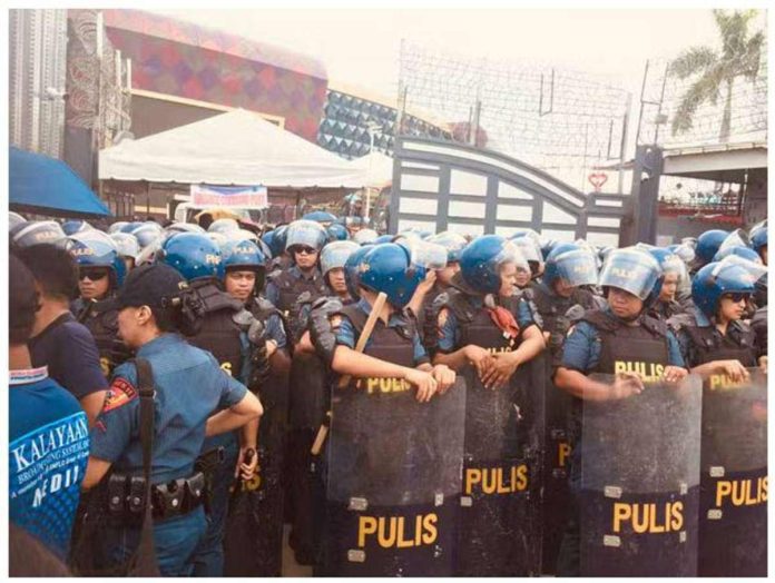 Palace Policemen prepare to enter the Kingdom of Jesus Christ Compound in Davao City in what Police Brigadier General Nicolas Torre III calls as the second phase of the operation geared at arresting Pastor Apollo Quiboloy who faces charges for violation of the Special Protection of Children Against Abuse, Exploitation, and Discrimination Act, and qualified human trafficking. PHOTO BY GERMELINA LACORTE | INQUIRER MINDANAO