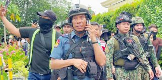 Police Regional Office 11 director Police Brigadier General Nicolas Torre III is seen with armed police officers inside the Kingdom of Jesus Christ Compound in Davao City on Saturday. PHOTO COURTESY OF SMNI NEWS