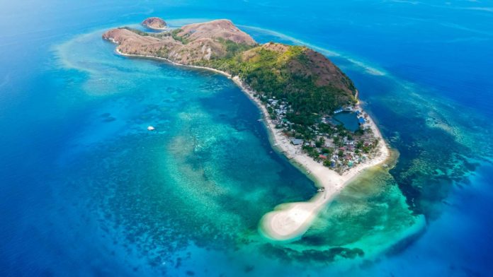 The-_hidden-gem-island_-Malalison-island,-is-a-small-picturesque-fishing-village-off-the-coast-of-Culasi,-Antique The hidden gem island. Malalison island, is a small picturesque fishing village off the coast of Culasi, Antique.