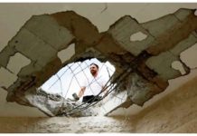 A man surveys damage to a building in Israel following a Hezbollah rocket and drone attack. REUTERS