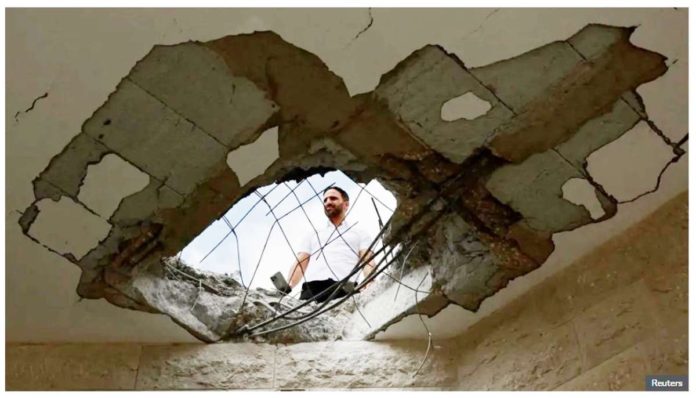 UN_1_resized A man surveys damage to a building in Israel following a Hezbollah rocket and drone attack. REUTERS