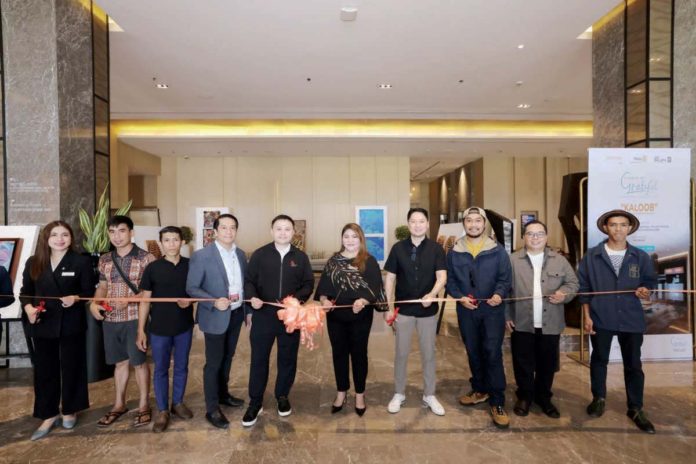 courtyard1_resized Courtyard by Marriott Iloilo launches a charity art exhibit dubbed “Art of Giving: Make it your piece of heart” with the theme, “A Series of Grateful Exhibition – KALOOB”, in partnership with Rotary Club Passport One, and in collaboration with One Gallery. Hotel Manager Joy Alonte (center) leads the ribbon cutting ceremony together with (from left) Courtyard by Marriott Iloilo Director of Sales Ellie Alarcon; featured artists Jeanroll Ejar and Tyronne Dave Espinosa; One Gallery – Art Gallery curator, owner, and operator Bem Enriquez; Cluster Director for Marketing Communications for Marriott Manila, Sheraton Manila, and Courtyard by Marriott Iloilo Archie Nicasio; Ilonggo collector and supporter Joebert Uygongco; featured artist Kristoffer Brasileño; Rotary Club Passport One President Ben Calderon; and featured artist Orland Espinosa.