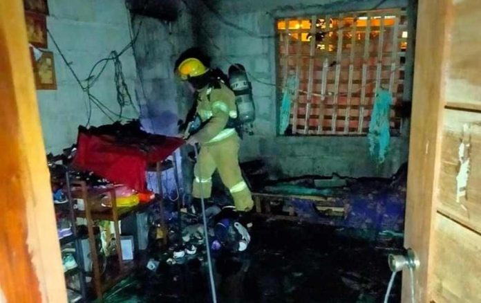 Firefighters conduct mopping-up operations inside the house of kagawad Juliet Estaquio in Sitio Lugutan, Barangay Igbonglo, San Jose de Buenavista, Antique. K5 NEWS FM SAN JOSE/FACEBOOK PAGE
