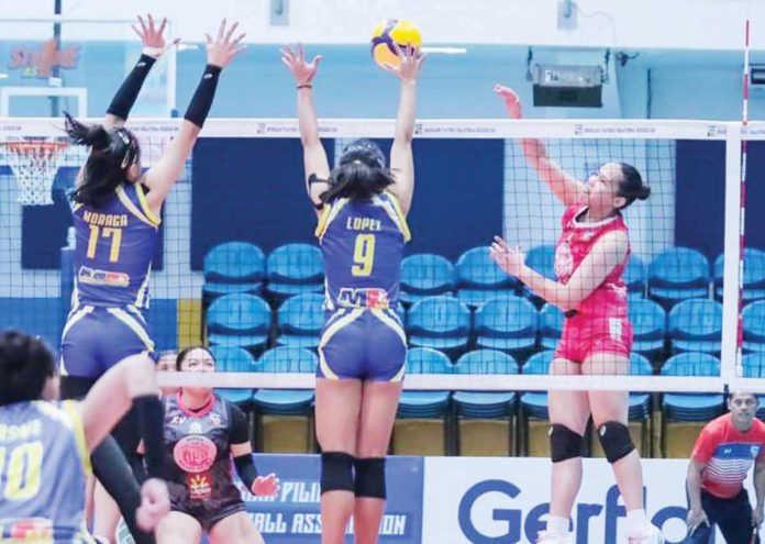 sports_Biñan_resized Negrense Erika Deloria of Biñan Tatak Gel 1-Pacman Partylist Volley Angels goes for an attack against a Negros-ICC Blue Hawks defender. MPVA PHOTO