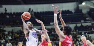 NLEX Road Warriors’ Myke Henry goes for a one-hander basket against the defense of Phoenix Fuel Masters’ Jayveous McKinnis. PBA PHOTO