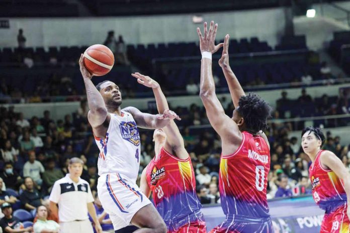 sports_PBA_resized NLEX Road Warriors’ Myke Henry goes for a one-hander basket against the defense of Phoenix Fuel Masters’ Jayveous McKinnis. PBA PHOTO