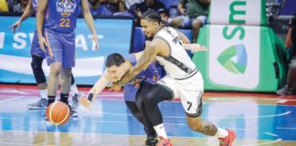 NLEX Road Warriors’ Robert Bolick Jr. dribbles the ball away from the defense of Blackwater Bossing’s James Kwekuteye. PBA PHOTO