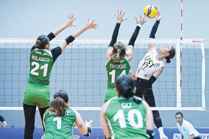 sports_Poyos_resized University of Santo Tomas Golden Tigresses’ Angeline Poyos tries to score against the defense of College of St. Benilde Lady Blazers’ Wielyn Estoque. V-LEAGUE PHOTO