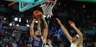 Team USA’s Devin Booker attacks two Brazilian defenders for a layup. REUTERS