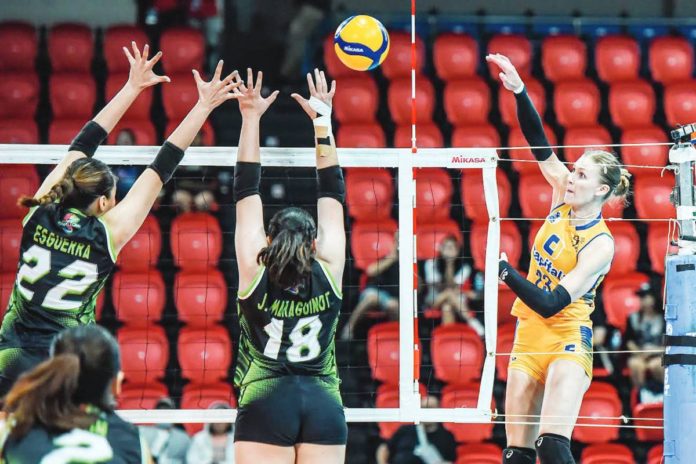 sports_Tushova_resized Capital1 Solar Energy Solar Spikers’ Marina Tushova converts against two NxLed Chameleons defenders. PVL PHOTO