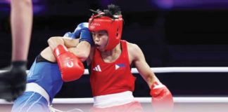 Filipina boxer Aira Villegas was held on by her opponent, Roumaysa Boualam of Algeria, during their 2024 Paris Olympics encounter. REUTERS