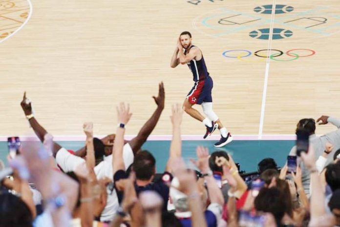 sports_clutch_resized Team USA’s Stephen Curry gestures to the French crowd after hitting a three-pointer during their 2024 Paris Olympics gold medal game against France. JAMIE SQUIRE/GETTY IMAGES