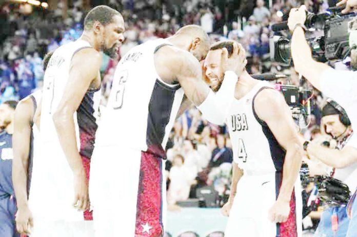 sports_curry_copy_resized Team USA’s Kevin Durant, LeBron James, and Stephen Curry celebrates after beating Serbia in the semifinals of the 2024 Paris Olympics men's basketball. AP PHOTO